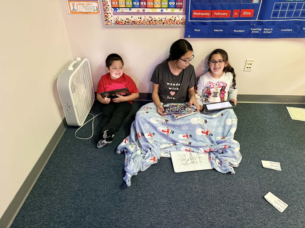 6th graders reading with the kindergartners 