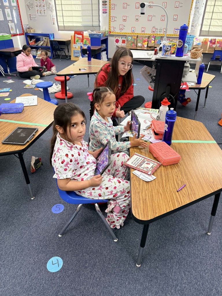 6th graders reading with the kindergartners 