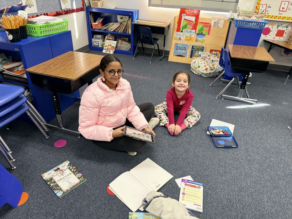 6th graders reading with the kindergartners 