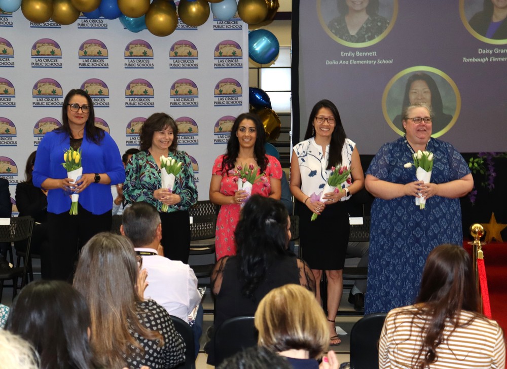 photo of five women holding flowers