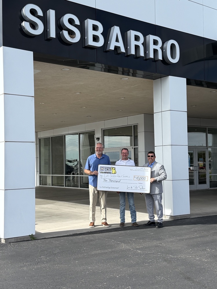 photo of three men holding a jumbo check