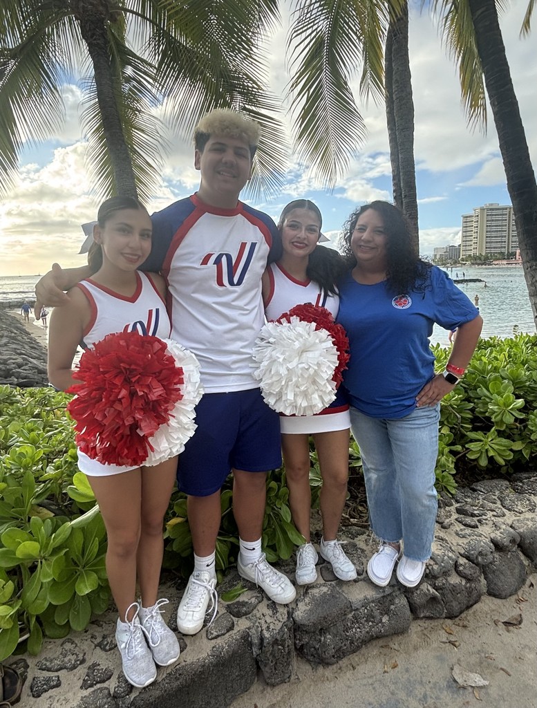 photo of three cheerleaders and their coach in Hawaii