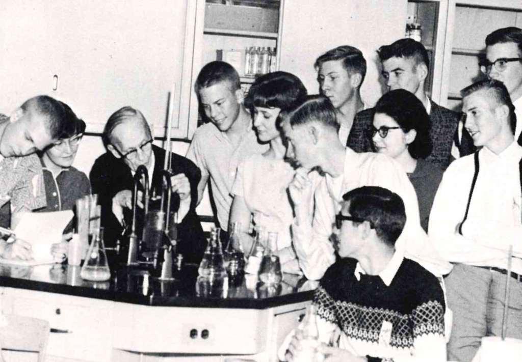 A look inside the science classroom at Las Cruces High School in 1965, where H.E. Alexander, known to students as “Mr. A,” demonstrates how to measure the percentage of oxygen in the atmosphere using a eudiometer tube while Bill Coleman records the data. Looking on are Celia Haas, Mary Alice Puga, Laura Hanna, Kirstan Schell, Mike Dennard, Linda Bailey, Kent Williston, Lou Ann Needham, Allen Orean, Frank Mejia, Dorothy Myers, Neil Loomis, Jerry White, Jack Saunders, James Wheeler and Richard Carlson. Captured in the 1965 LCHS yearbook, the photo is a great reminder that hands-on learning and a little scientific curiosity have long been part of the Las Cruces High School experience. This is Las Cruces Public Schools, then and now.