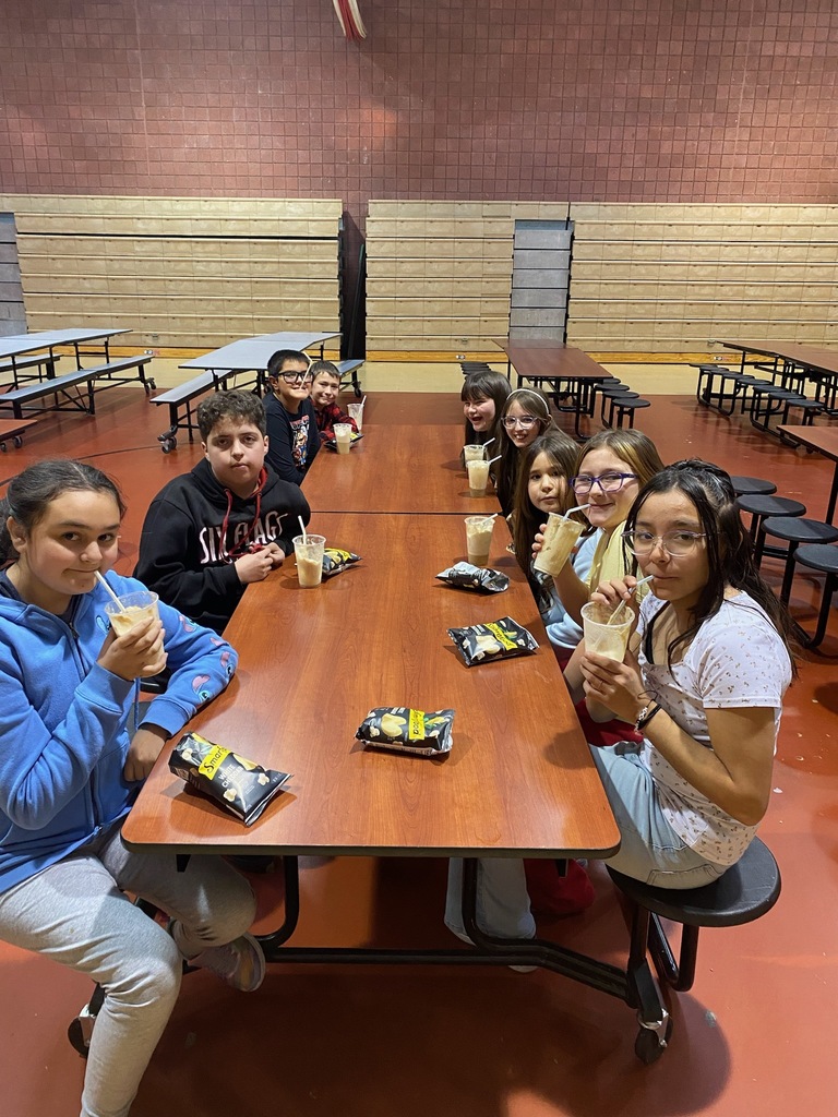 Students smiling around a table