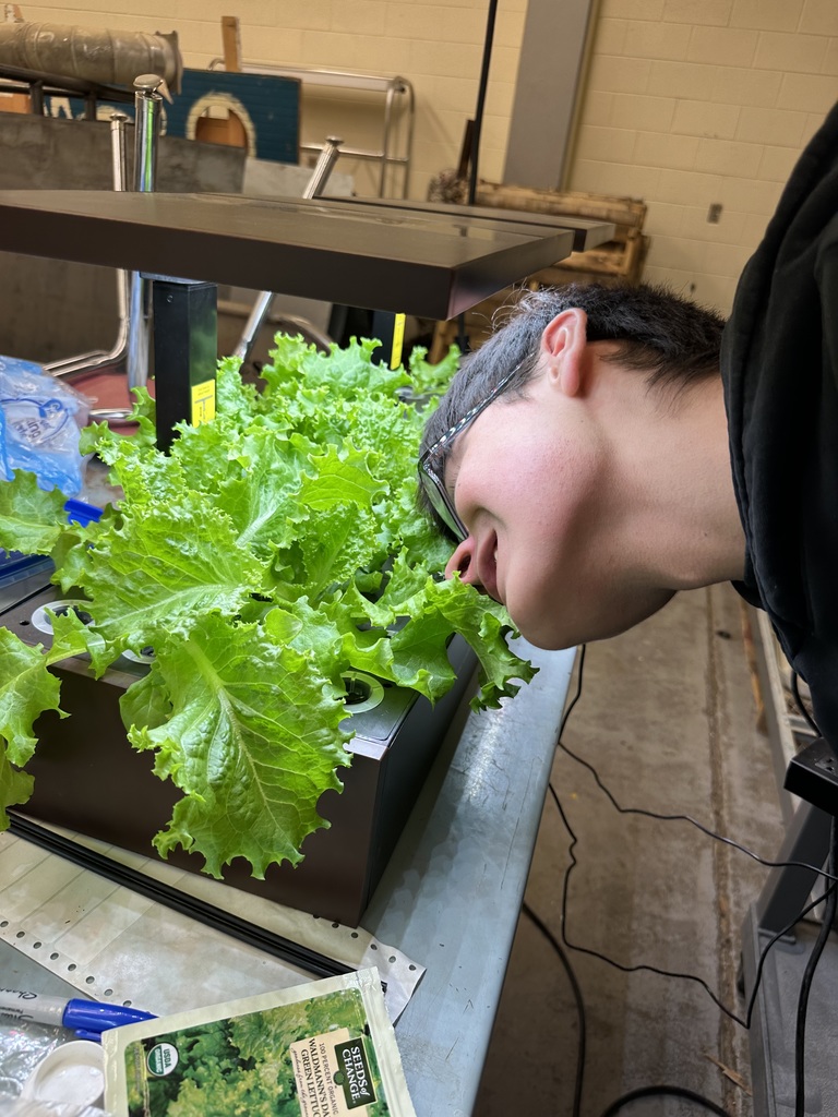 student smelling a plant