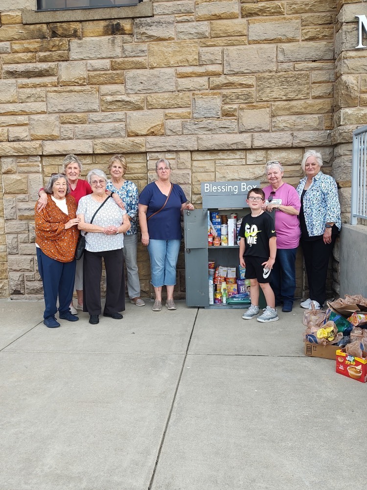 student and group of people restock blessing box