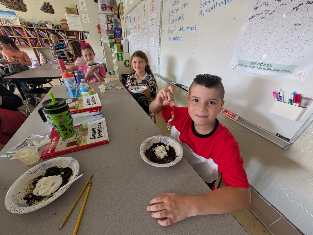 Students eating a gummy worm pudding treat