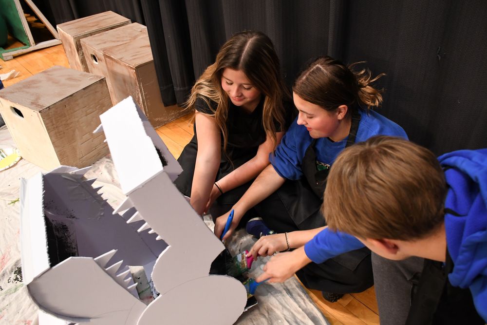 students painting a dragon head