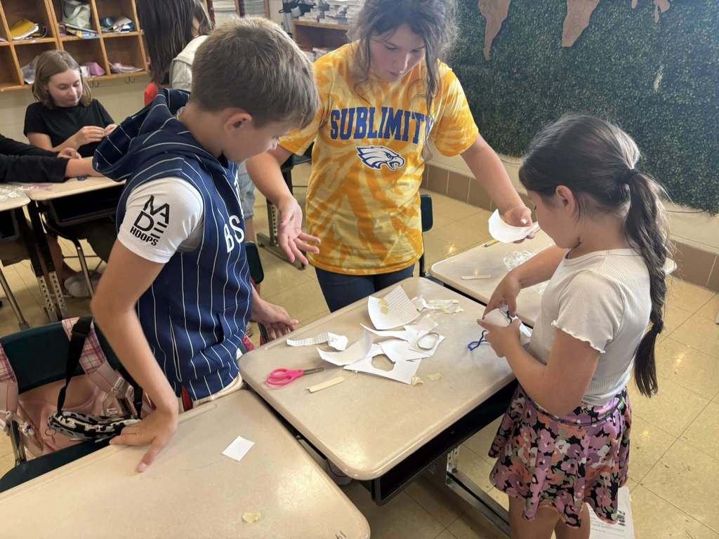 Students discussing and assembling container