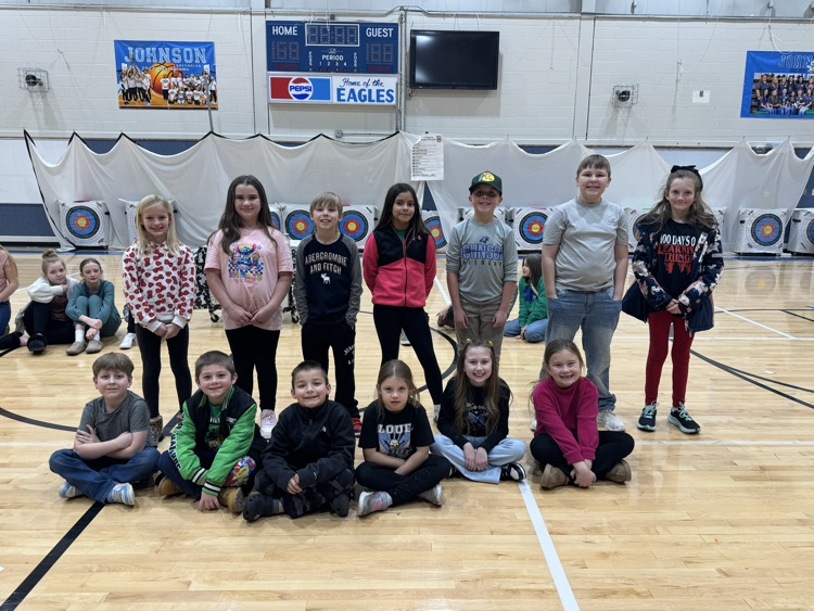 These students are the classroom selections for the December student of the month. The character trait theme this month was respect. The students are arranged in two rows with the front sitting on the gym floor in the back standing behind them.