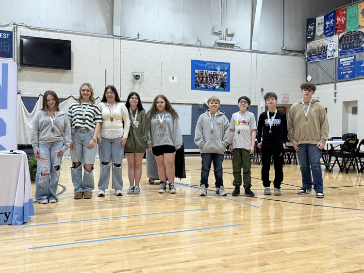 Students stand in line in the Johnson Elementary gym with certificates and medals celebrating their 2025 KSA test scores  