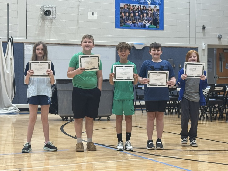 Students stand in line in the Johnson Elementary gym with certificates and medals celebrating their 2025 KSA test scores. 