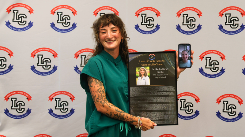 Ellie Stanko accepting recognition on behalf of her mother Dr. Shelley Stanko who joined via phone