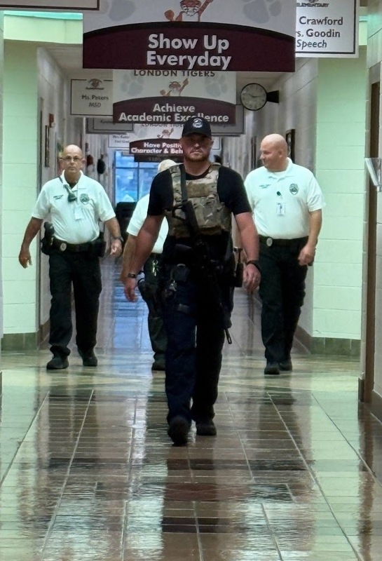 London PD and SRO's training in hallway at London Elementary