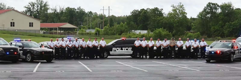 LCPS Police Staff with their cruisers outside