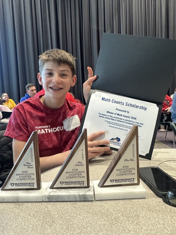 cooper robinson poses ith trophies