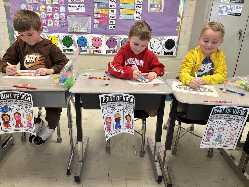 three students making laminated teeth dirty with markers