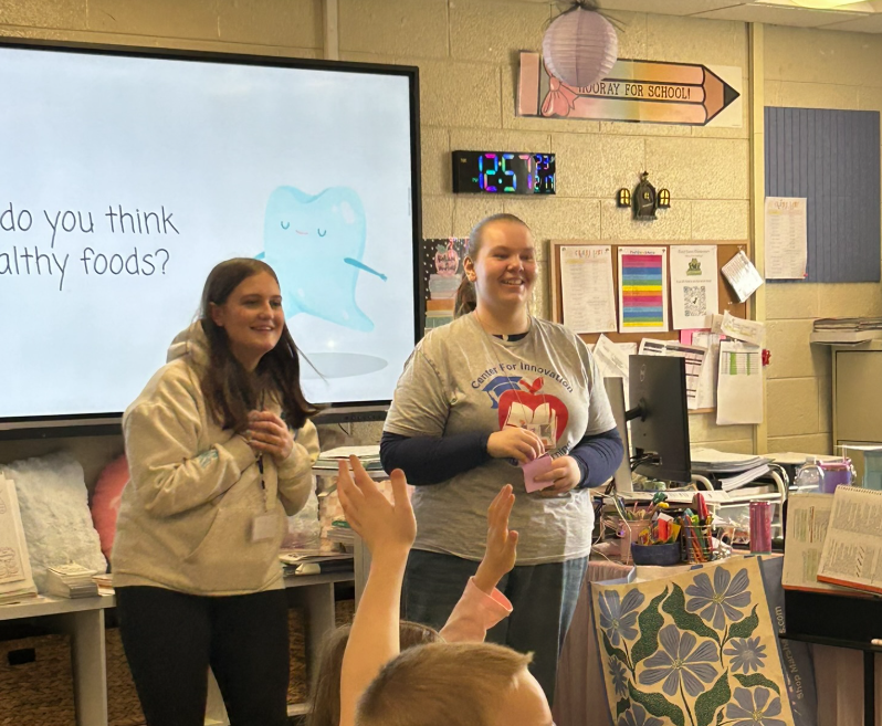 Students raising hands to ask questions to the presenters