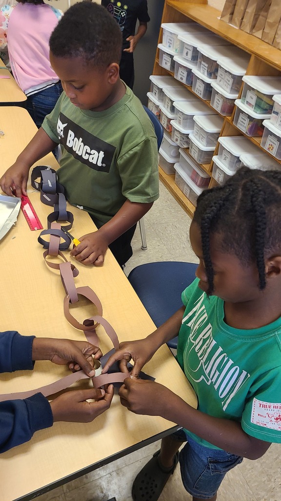 Students making a paperchain.