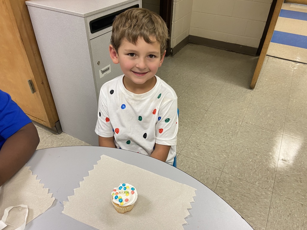 Student sitting at the table with a cupcake