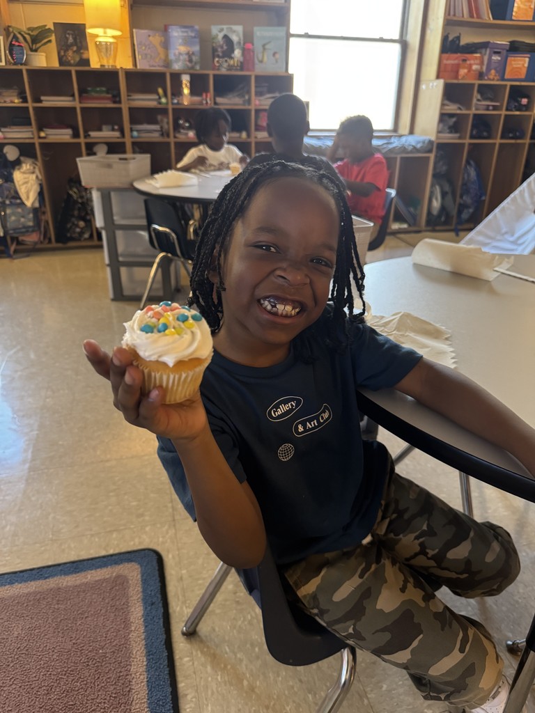 A student holding a cupcake.