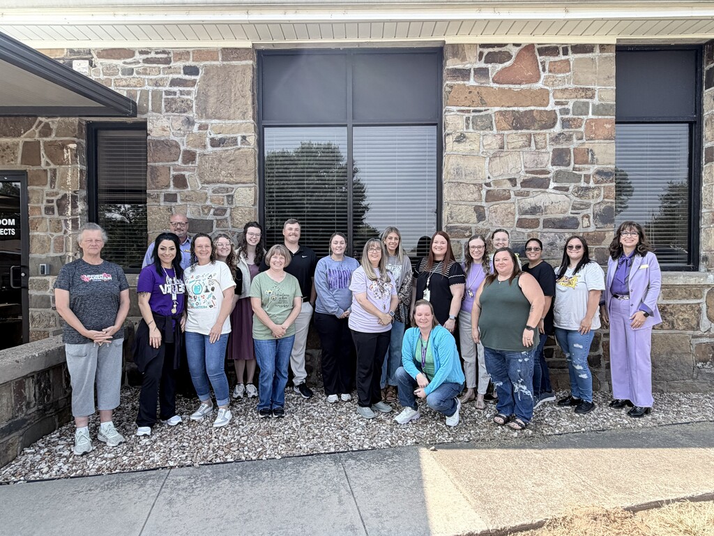 Photo of new staff members standing outside the Administration Office.