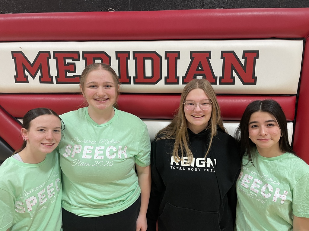 Four teenage girls stand in front of a backdrop that says Meridian.