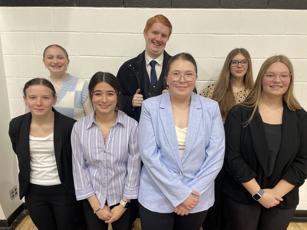 7 students pose in suits