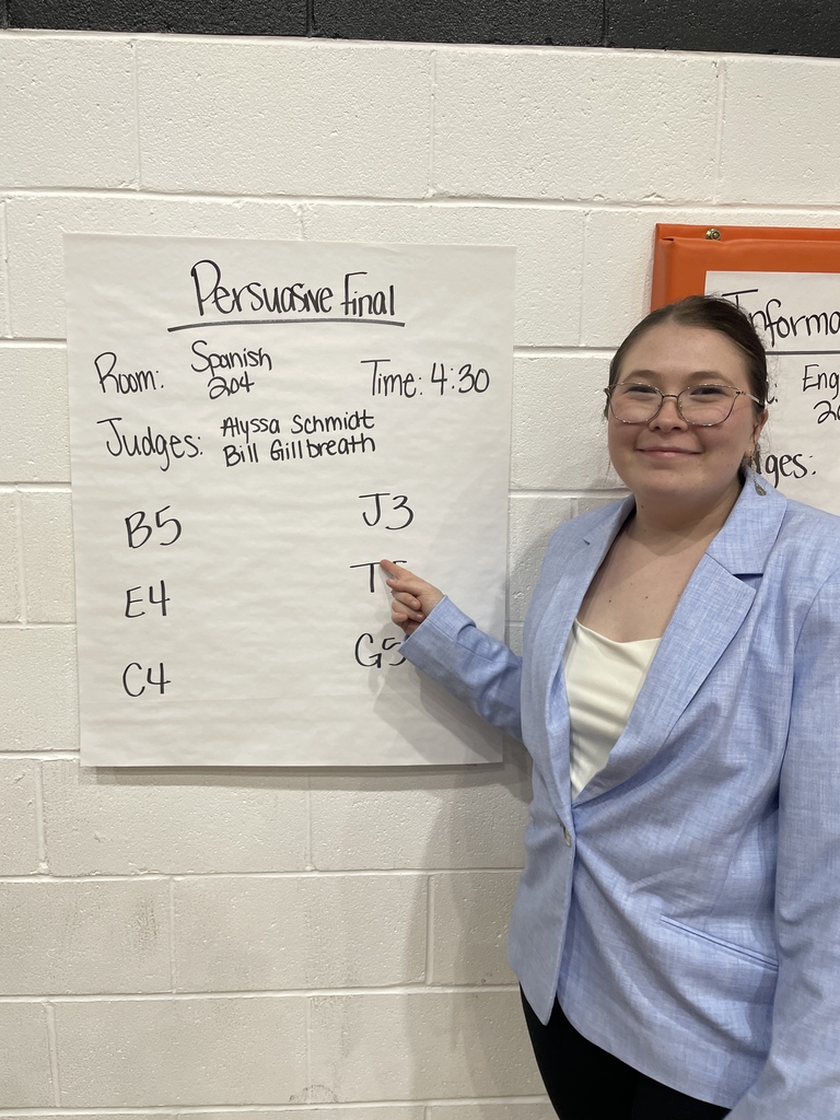 Student points at finals board