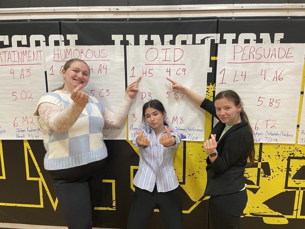 Three girls with finals paper