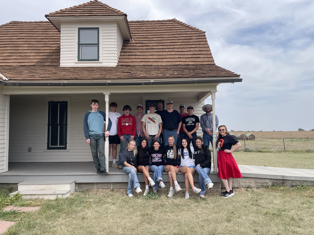 class in front of prairie house