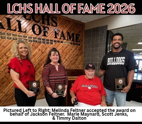 Four adults pose for a photo with awards. Behind them is a wall that says "LCHS Hall of Fame 2026."