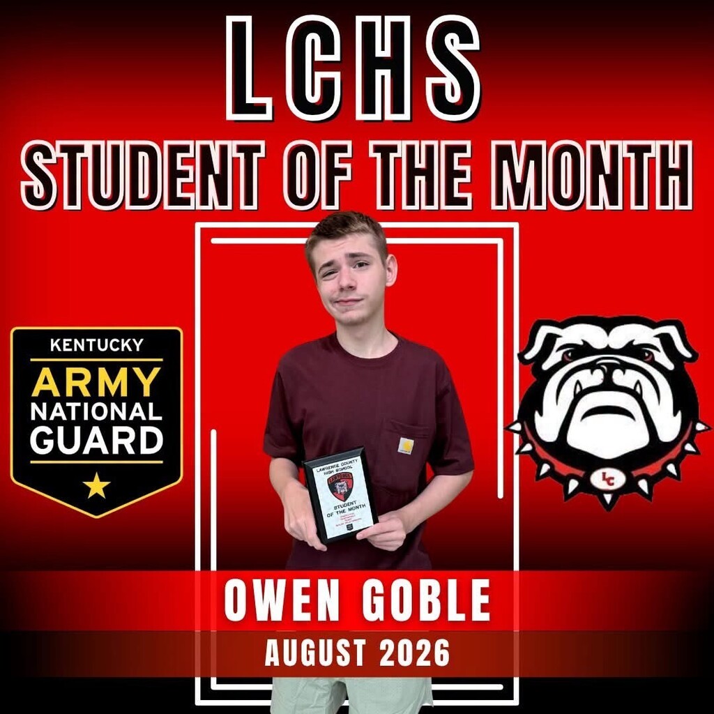 A young man stands holding a plaque with "Student of the Month" in red letters.