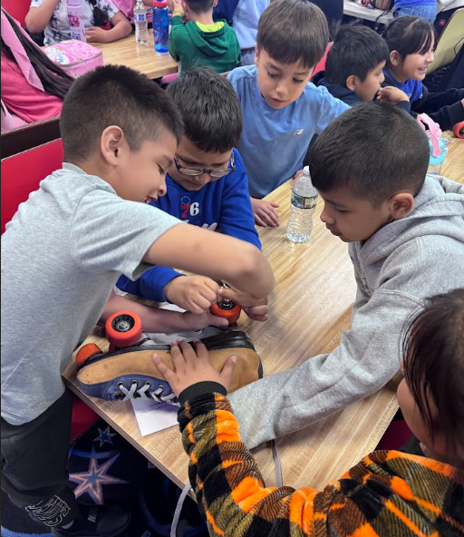 Ms. Perez's students taking apart a roller skate.