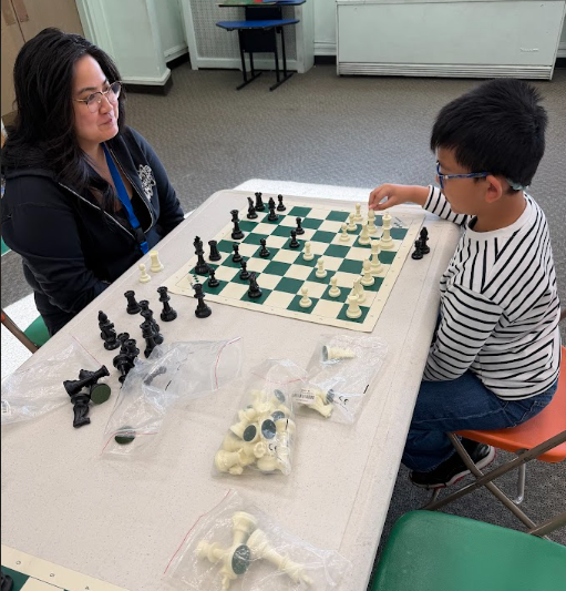 Ms. B playing chess with student