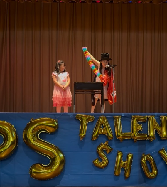 Anabela with assistant, Amber, performing a magic show