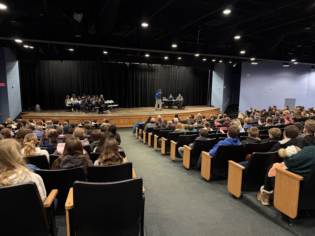 A photo of the Owen Bray Auditorium full of students watching someone on stage at a microphone for the Spelling Bee.