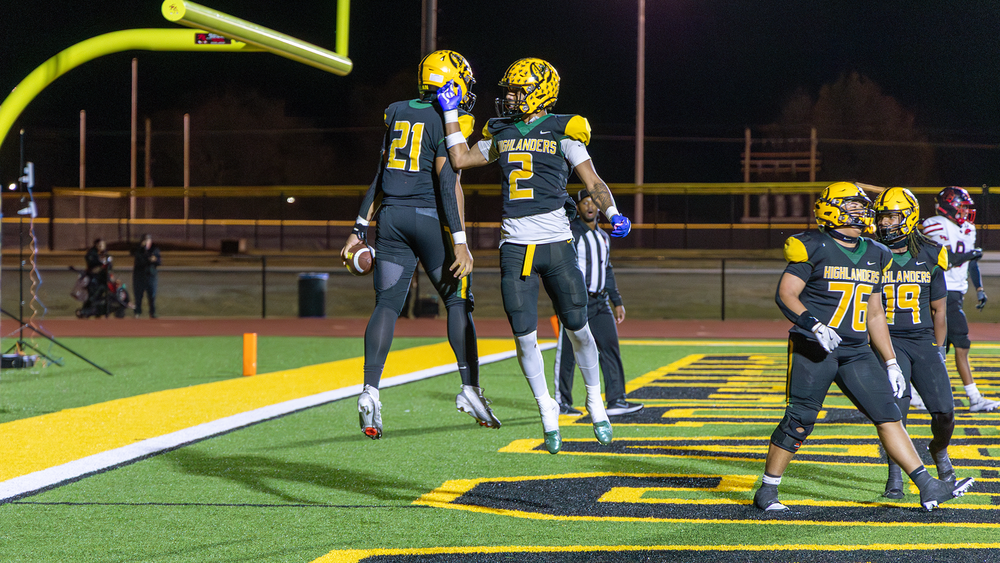 Two MacArthur High School football players celebrate after a playoff touchdown