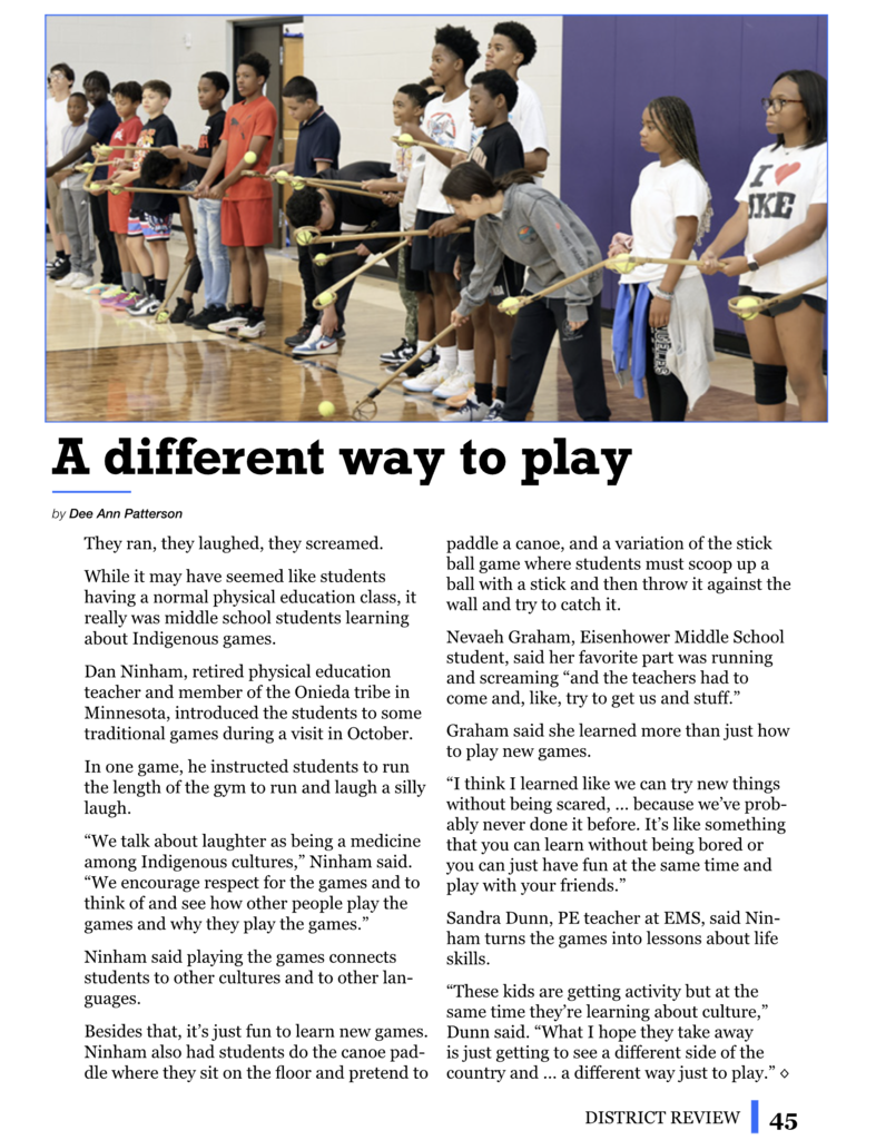 Children hold sticks in gymnasium. Text overlay. Background is blurry. Text reads "A different way to play."