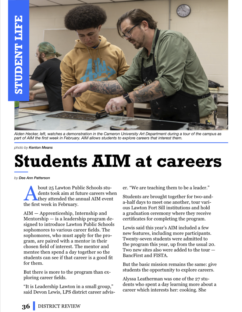 Two students, one with tattoos, work at a station. A sign reads "Students AIM at careers". The background shows a clock and another student.