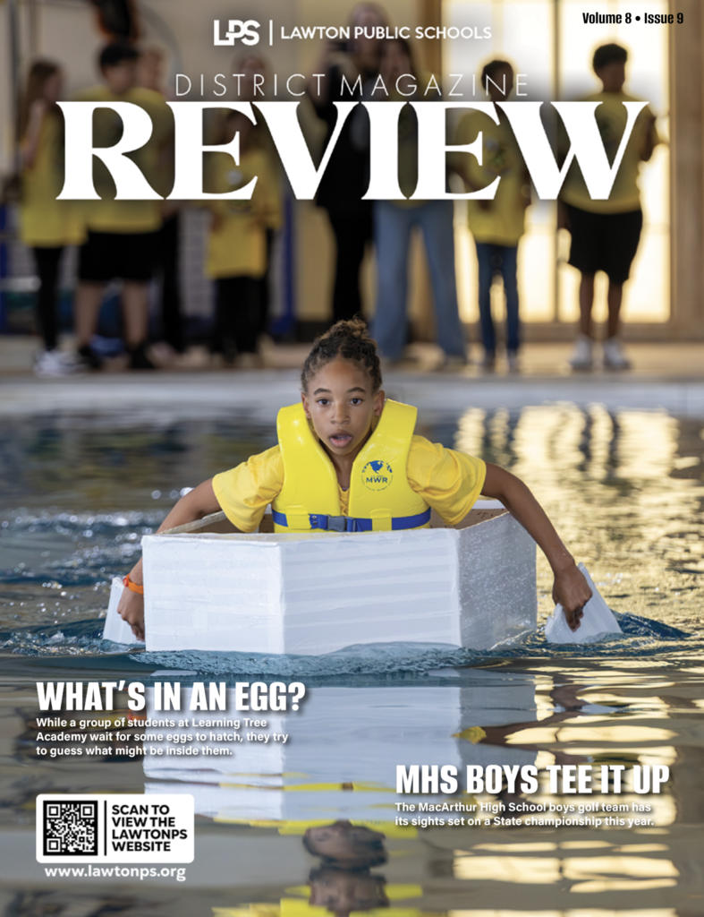 A magazine cover shows a young child in a yellow life vest in a pool. Other children are blurred in the background.