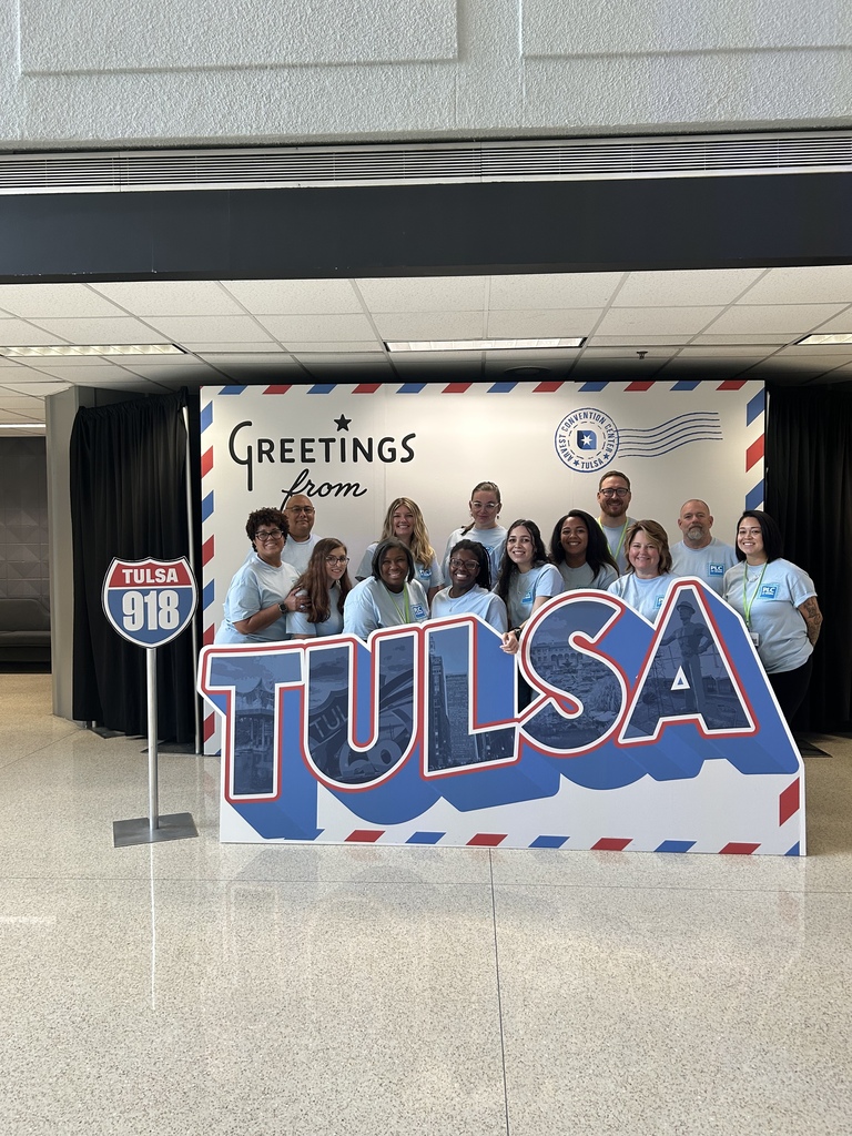 A group photo behind the words TULSA.