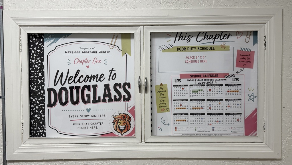 A white display case with two posters. One poster reads, "Welcome to Douglass" with a lion graphic. The other poster has text and a calendar.