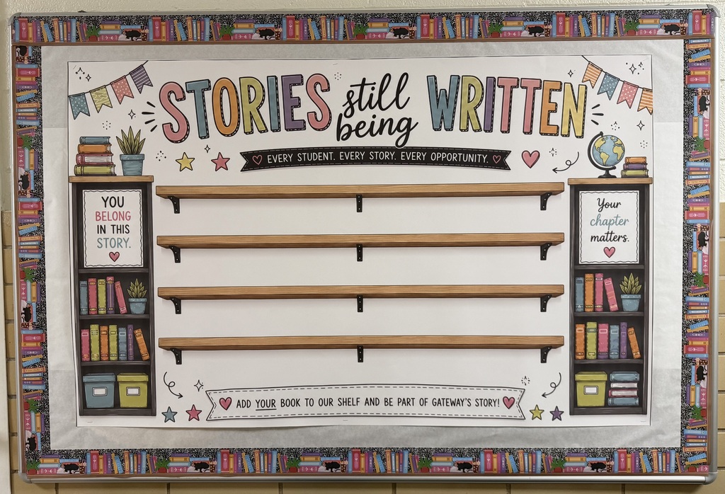 A classroom bulletin board displays wooden shelves with books, a globe, and banners. A quote reads "Stories still being written."