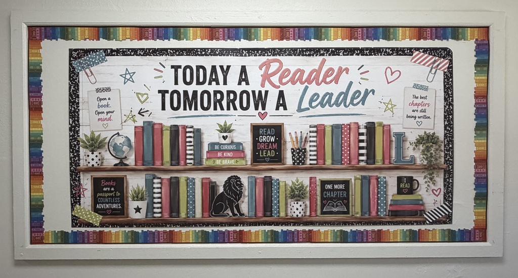 A colorful bulletin board with books, a globe, plants, and the slogan "Today a Reader, Tomorrow a Leader".