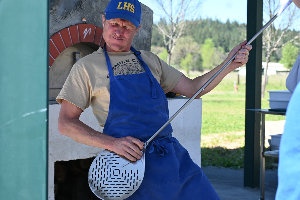 Principal Tim Henry "plays" the pizza 