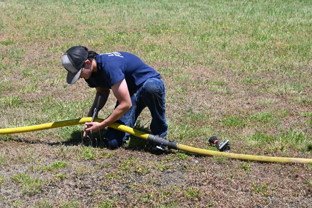 Student attaches fire hose