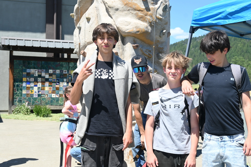 Middle school students in front of rock climbing wall
