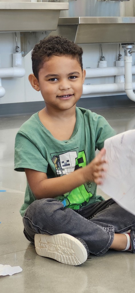 Kindergartners share their drawings about family in art.