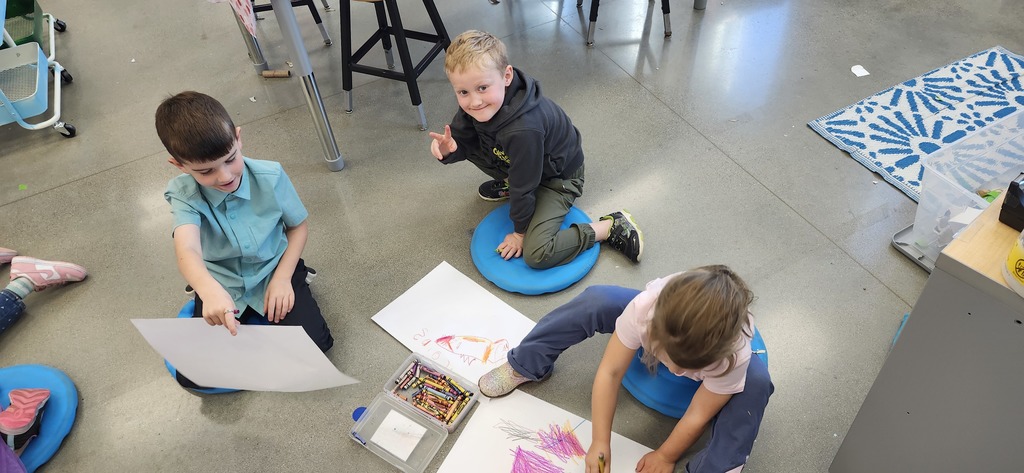 Today in art kindergarteners explored mixing colors with crayons and enjoyed getting to draw laying or sitting on the floor while drawing...a different body position is fun to try!